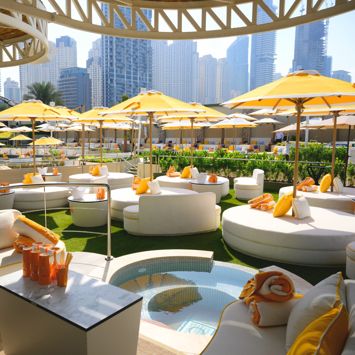 O Beach VIP Cabanas with the Dubai Marina in the background. Umbrellas, towels, private jacuzzi and branded cups